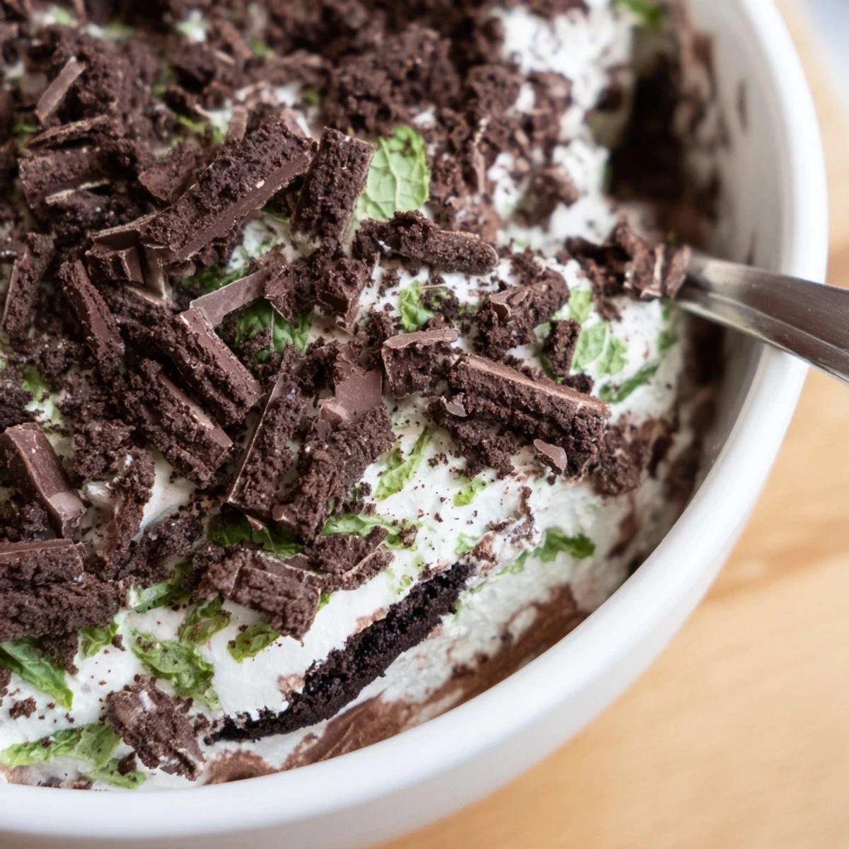 Creamy chocolate and crushed Peppermint Crisp layered in a glass, topped with grated chocolate and minty crumbs.
