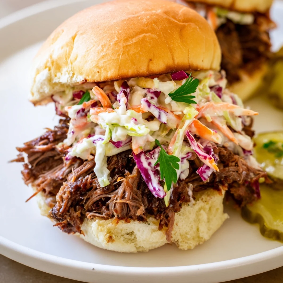 Juicy shredded brisket piled high on soft slider buns, topped with tangy homemade coleslaw for a classic American game-day bite.