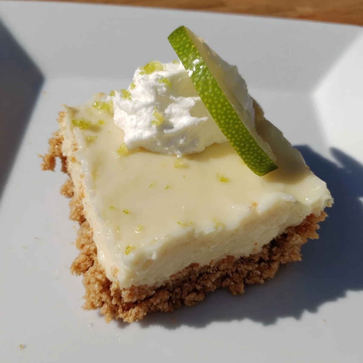 Cut slices of Key Lime Pie Bars reveal the creamy, tangy interior against the crunchy, buttery graham cracker base.