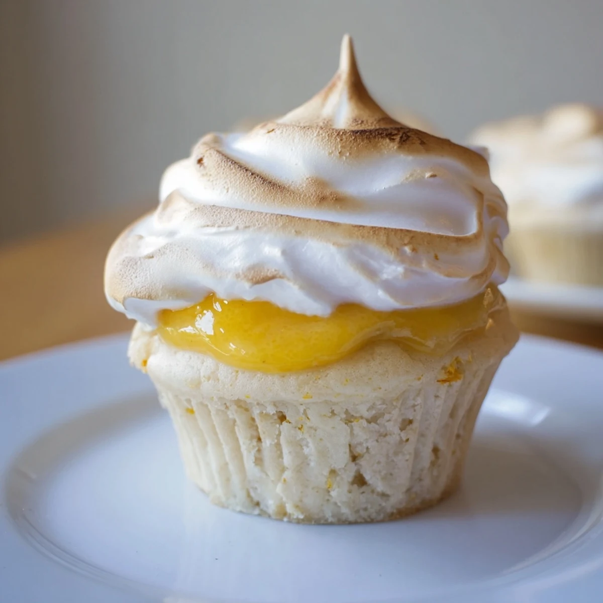 Delicious Lemon Meringue Cupcakes plated on a ceramic dish, perfect for a sweet summer dessert party.