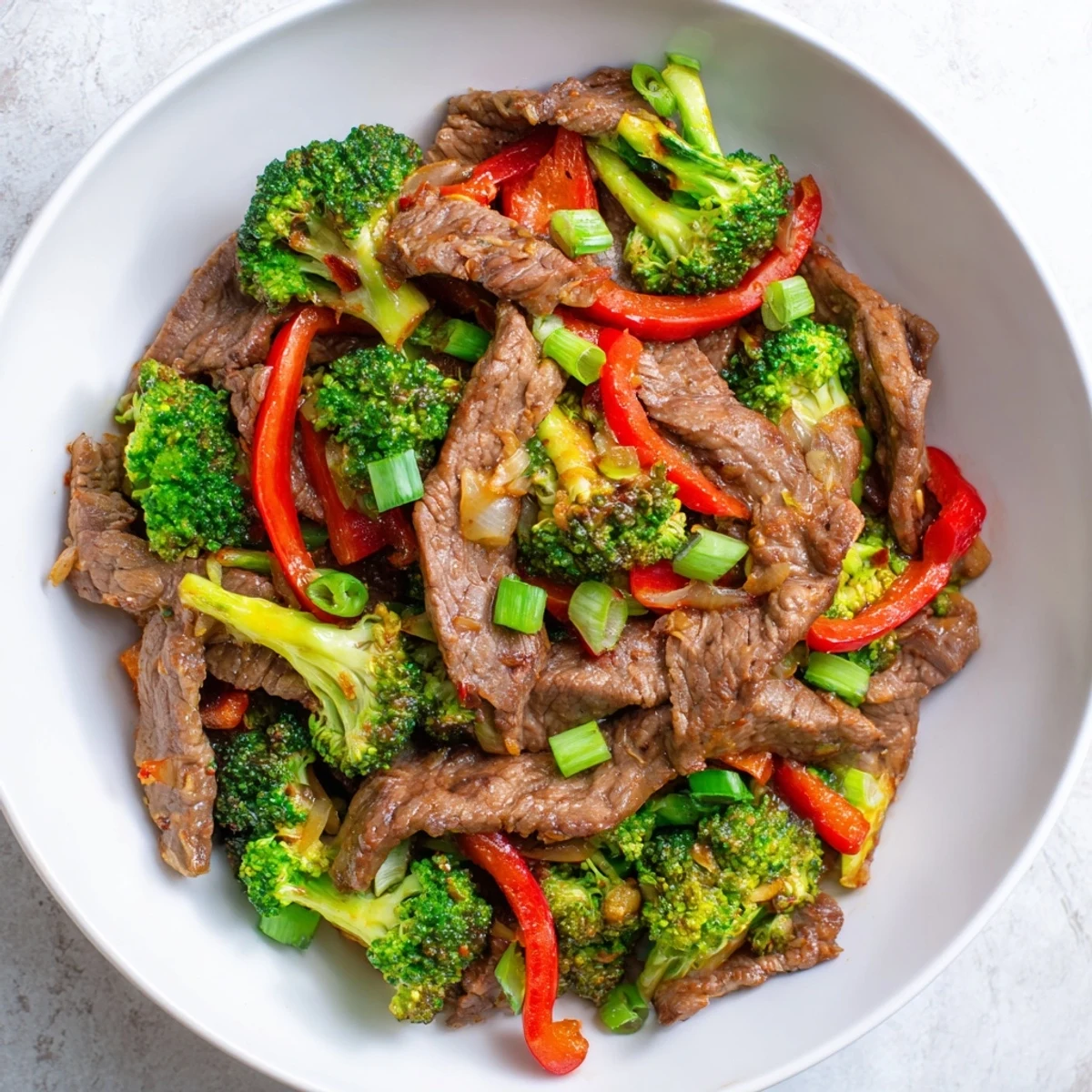 Tender beef strips and bright green broccoli stir fry with a savory ginger sauce, creating a colorful weeknight main dish.
