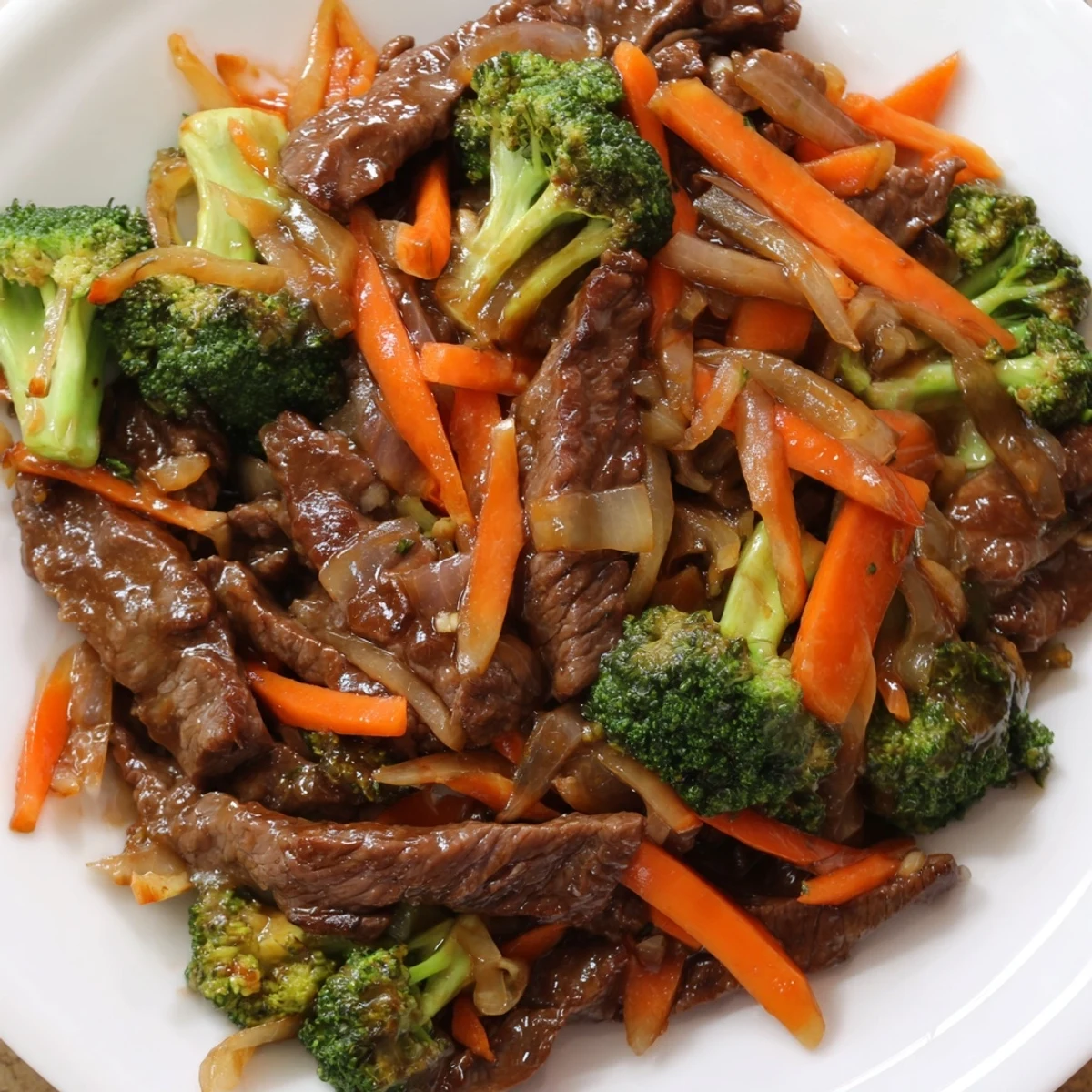 Tender beef and crisp broccoli florets glisten with savory ginger soy sauce in this Beef and Broccoli Stir Fry with Ginger Soy Sauce served over fluffy white rice.