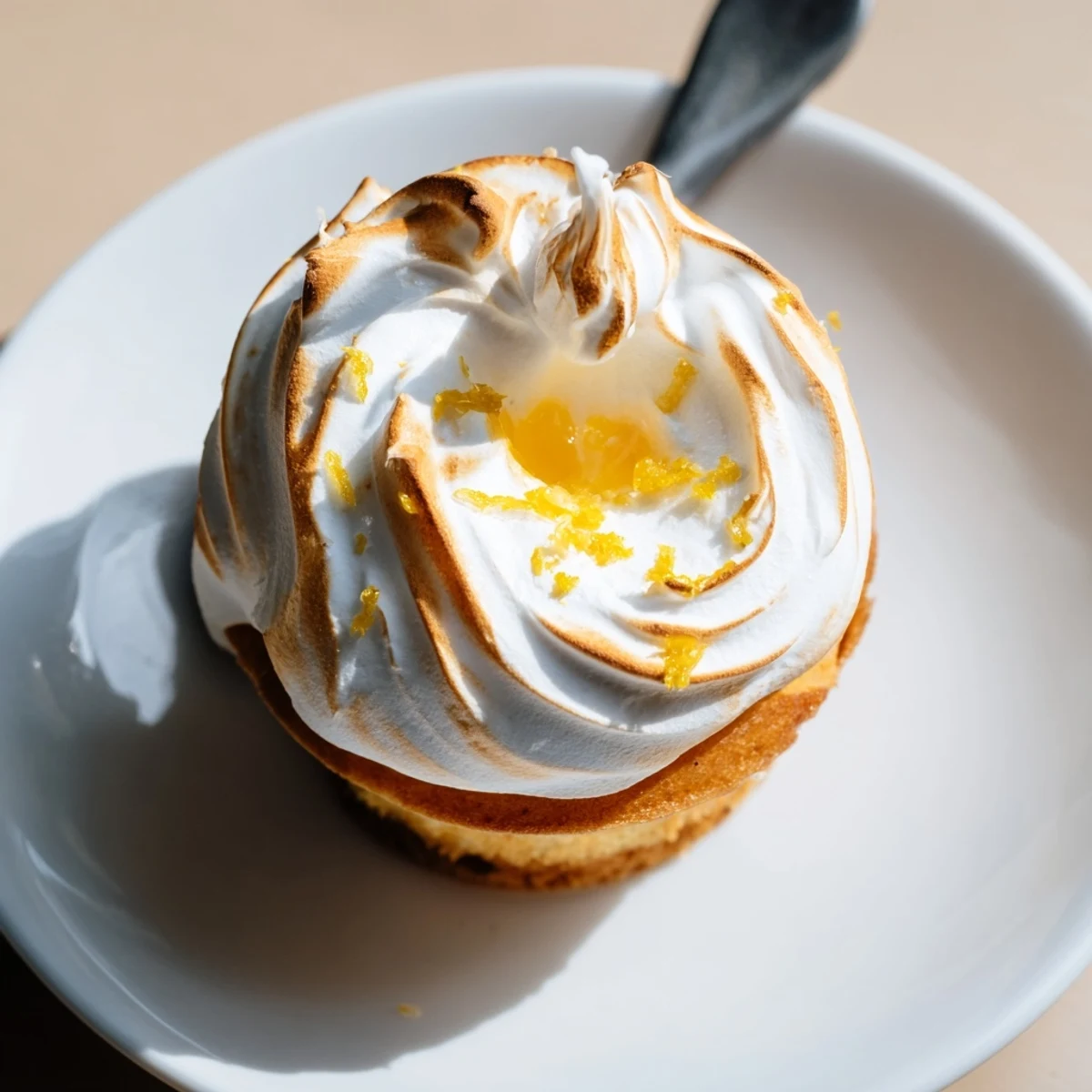 These delicate lemon meringue cupcakes showcase fluffy meringue peaks and tangy lemon curd filling, perfect for an American dessert spread.