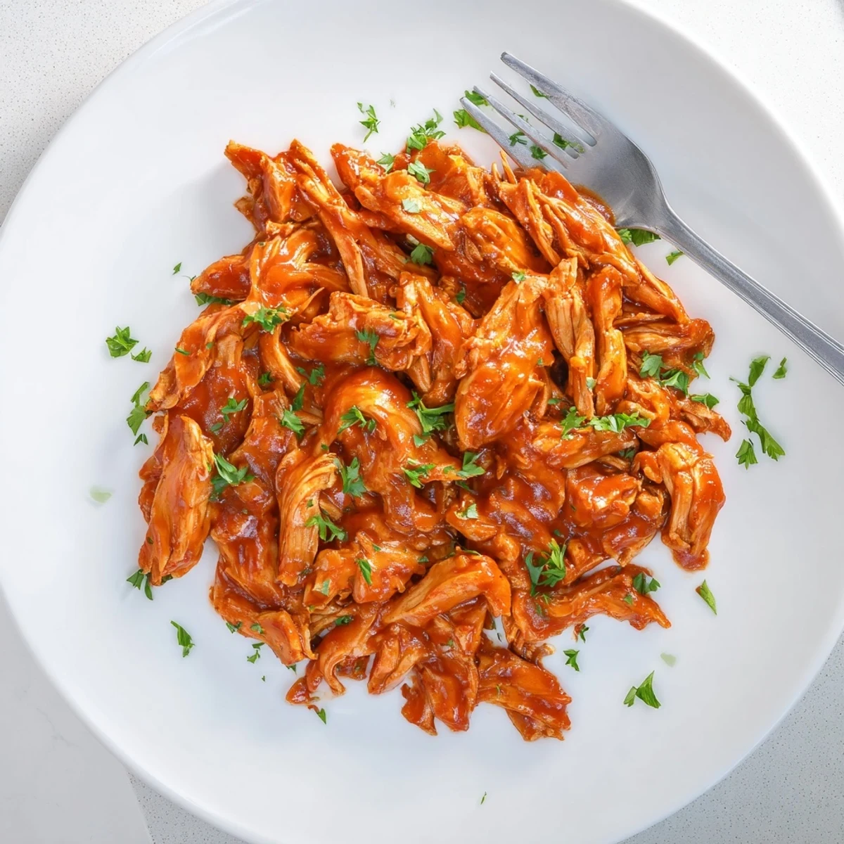 Tender chicken breasts coated in Sweet Baby Rays Crockpot Chicken, slow-cooked until glazed in a sweet and tangy barbecue sauce.