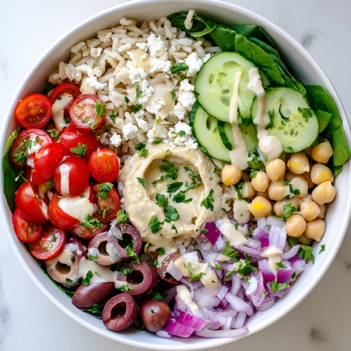 Healthy Mediterranean rice bowl featuring vibrant chopped vegetables, olives, and protein-rich chickpeas ready for serving