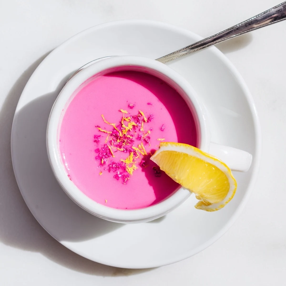 Golden pink lemon curd filling layered between vanilla cake slices for dessert