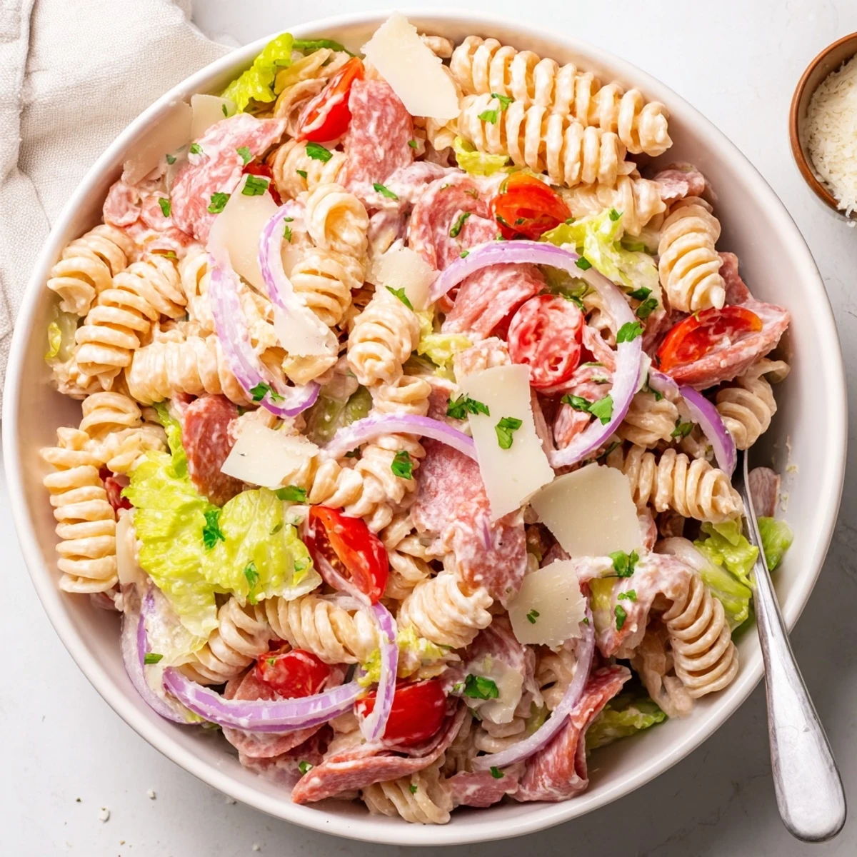 Colorful Italian grinder pasta salad tossed with tangy pepperoncini, cherry tomatoes, and savory cured meats