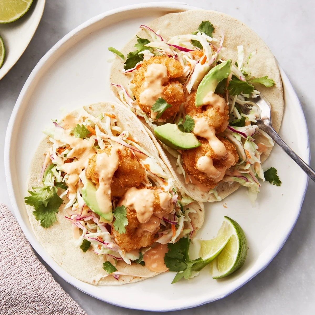Warm tortillas topped with spicy Bang Bang shrimp, fresh avocado, and crunchy cabbage slaw