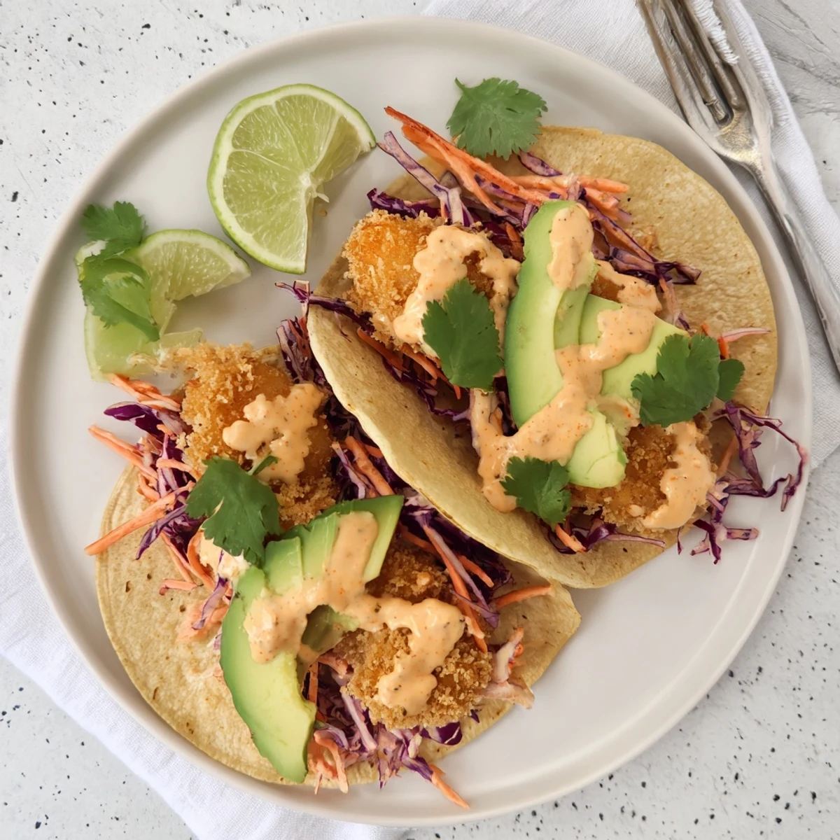 Crispy fried shrimp in tangy Bang Bang sauce served inside soft flour tortillas with lime