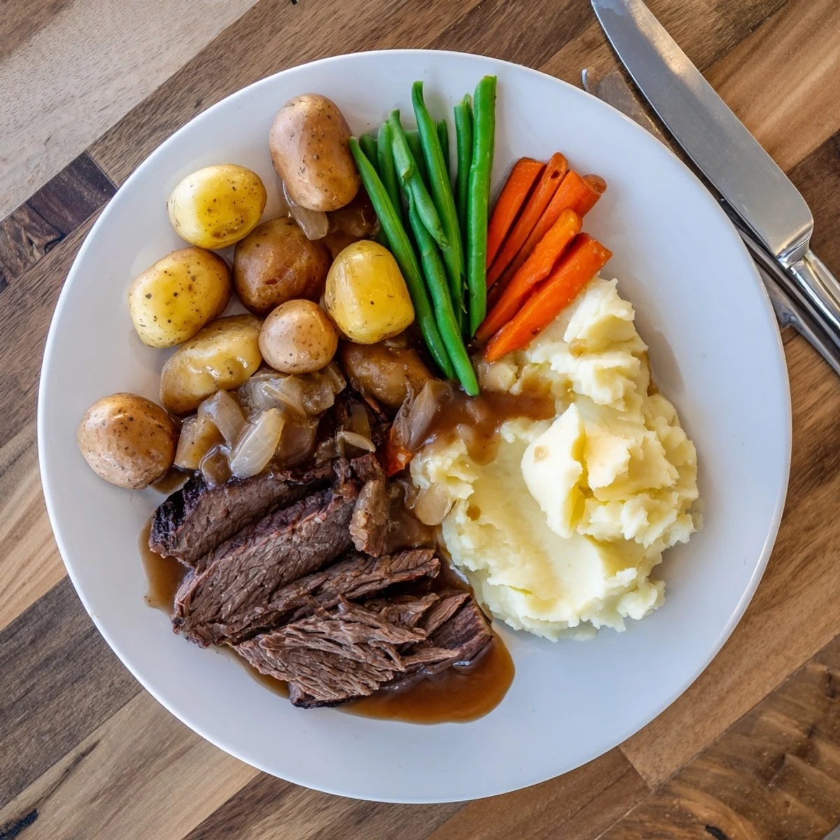 Tender Southern style pot roast with rich gravy served over fluffy mashed potatoes and buttery green beans