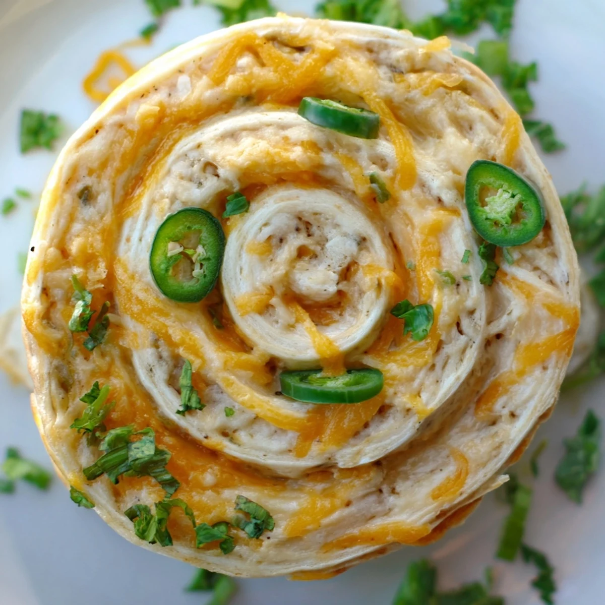 Warm easy jalapeno popper pinwheels fresh from the oven with melted cheese and visible diced peppers