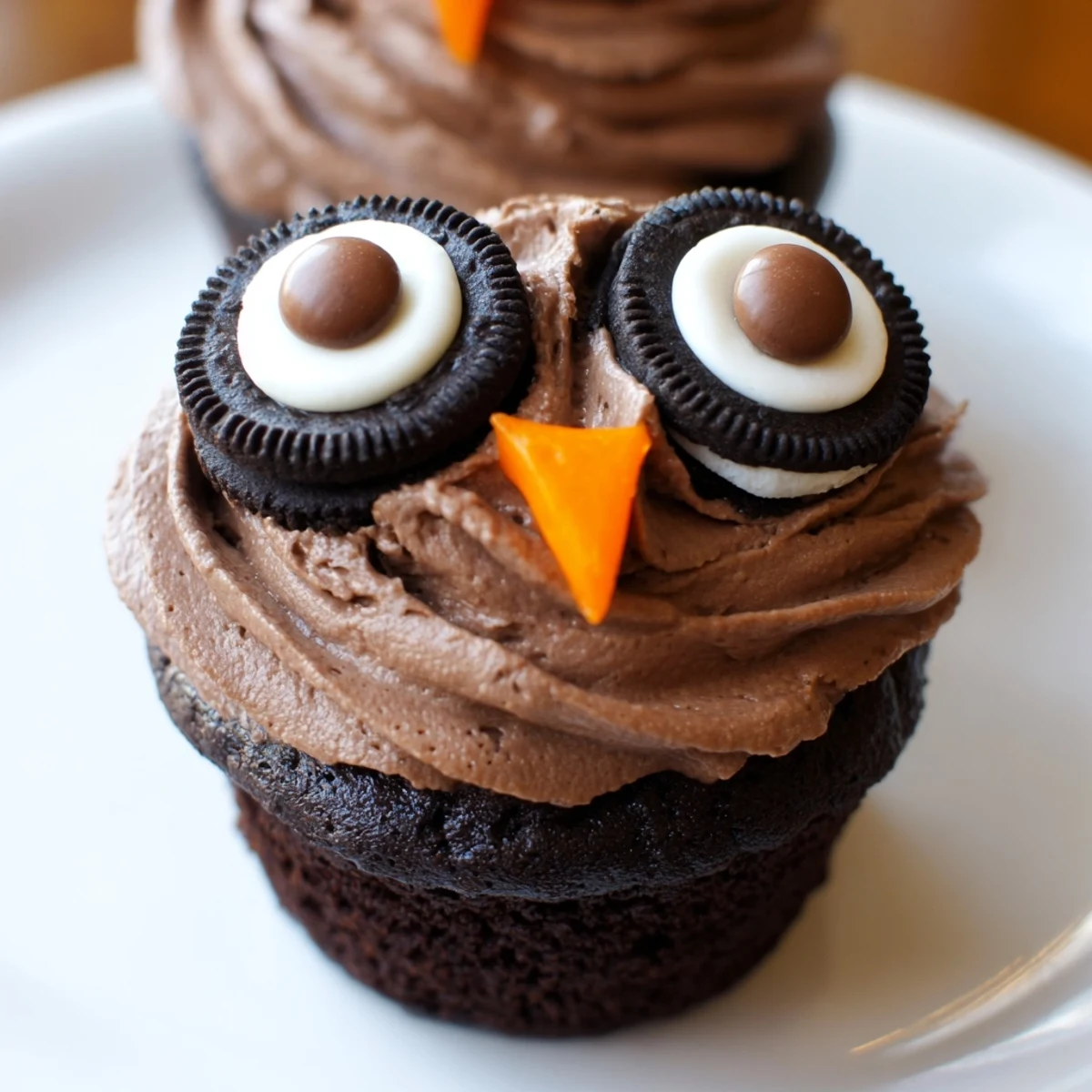 Chocolaty Oreo Owl Cupcakes featuring crunchy cookie owl eyes arranged on a decorative dessert platter