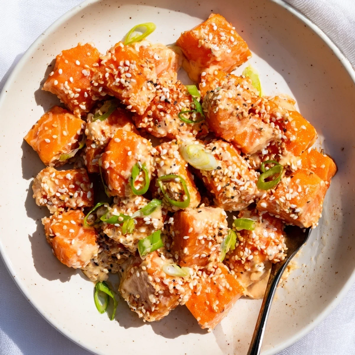 Serve warm Bang Bang Salmon Bites over jasmine rice or crisp salad
