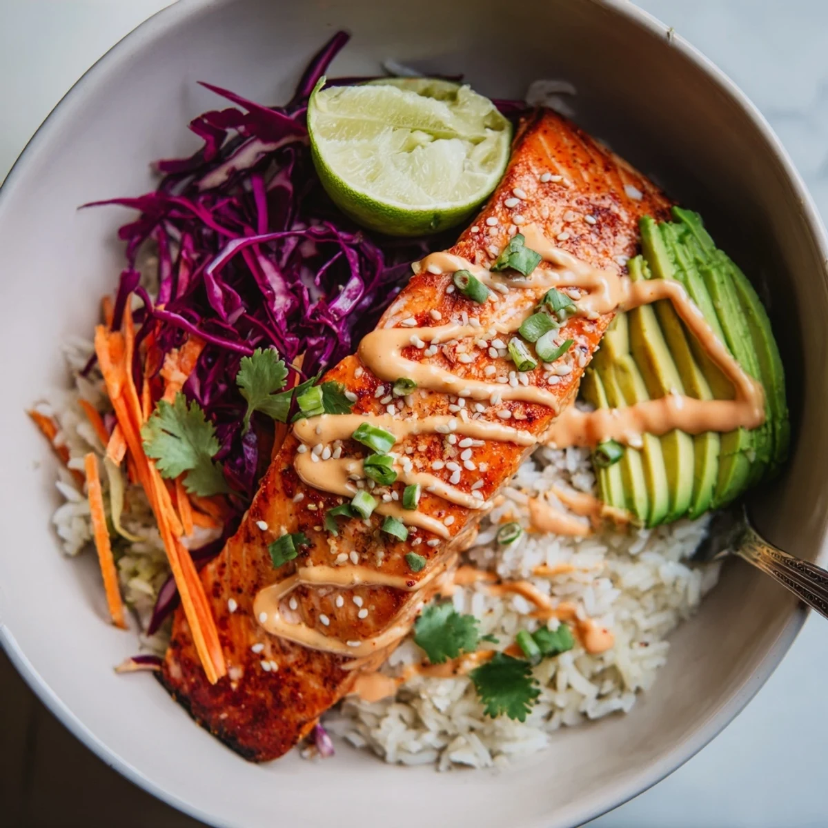 Bang Bang Salmon Bowls with flaky roasted salmon, creamy spicy sauce drizzled