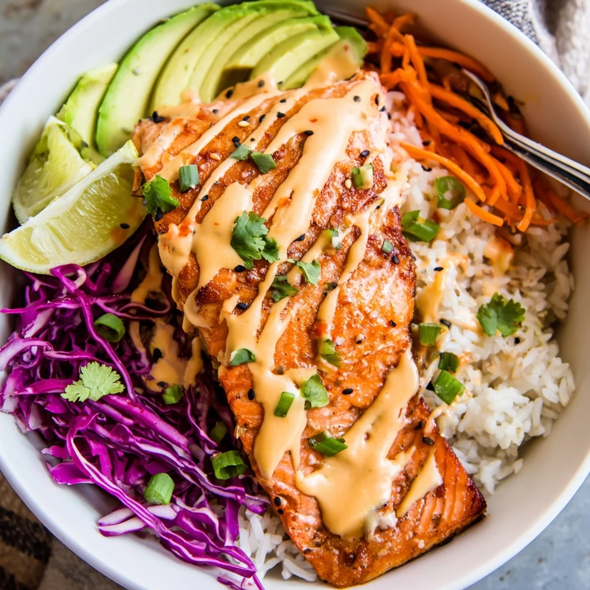 Bright Bang Bang Salmon Bowls served with lime wedges, sesame crunch, cilantro