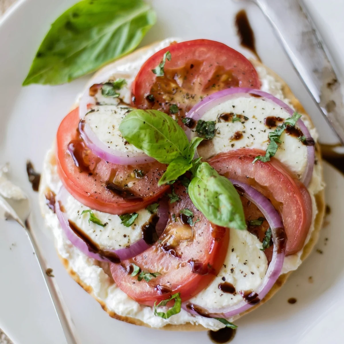 Caprese Pita Pizza With Whipped Garlic Feta, golden edges and fresh basil  