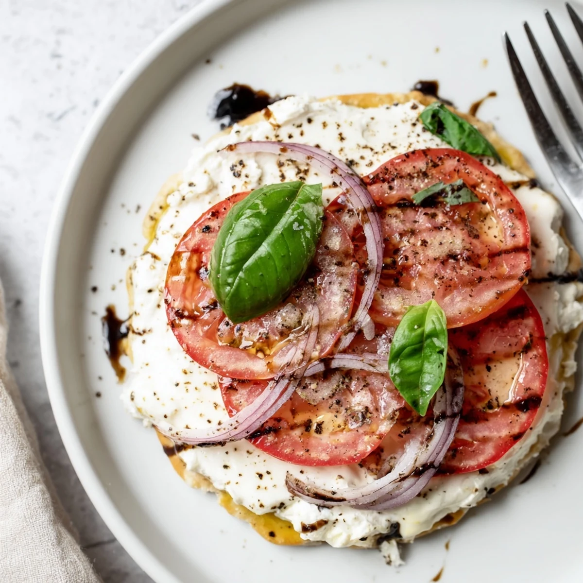 Warm Caprese Pita Pizza With Whipped Garlic Feta, melted mozzarella and tomatoes  