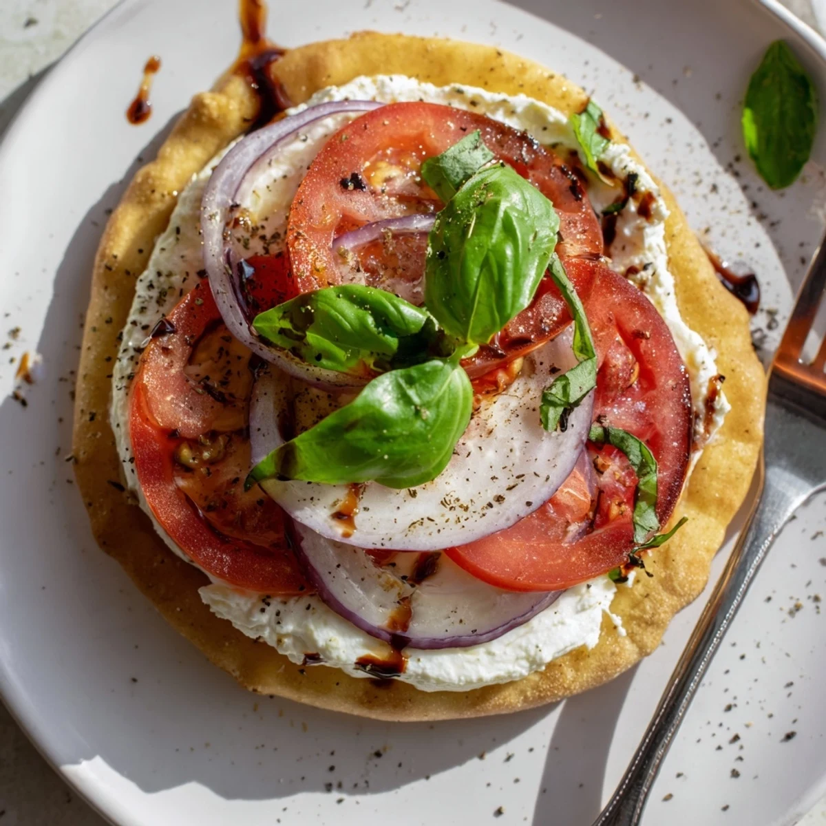 Sliced Caprese Pita Pizza With Whipped Garlic Feta, creamy spread and balsamic drizzle