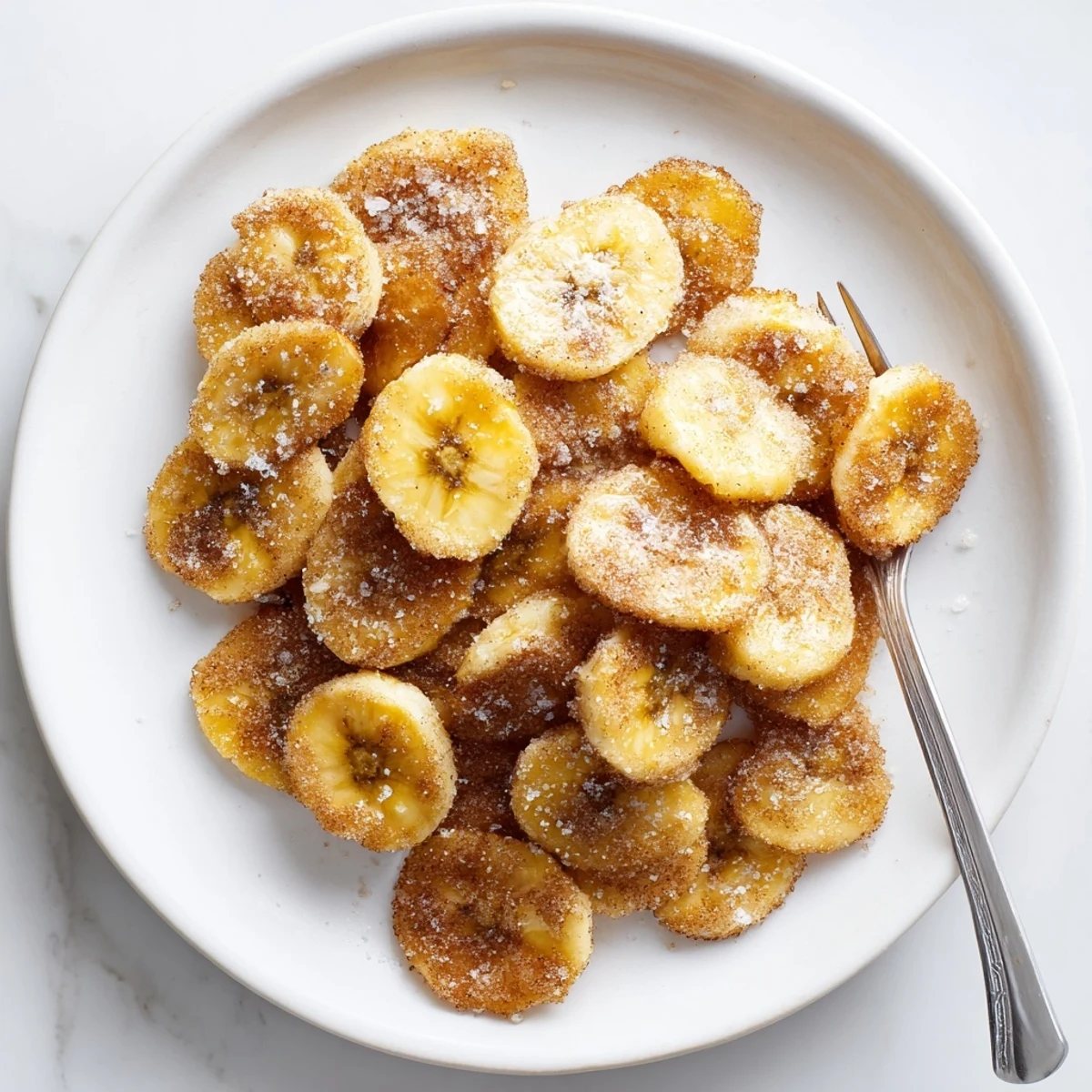 Golden Crispy Cinnamon Sugar Air Fryer Banana Chips crackling with sweet spiced aroma.