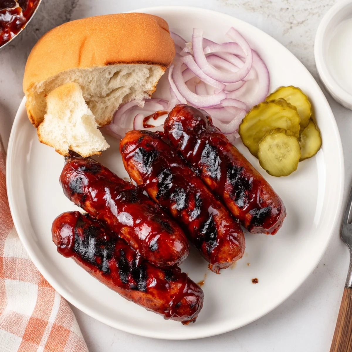 Savory BBQ Sausage Recipe glistening with caramelized sauce, ready with coleslaw.
