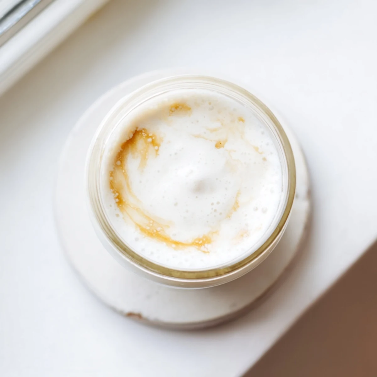 Silky smooth homemade almond milk recipe displayed in a clear mason jar