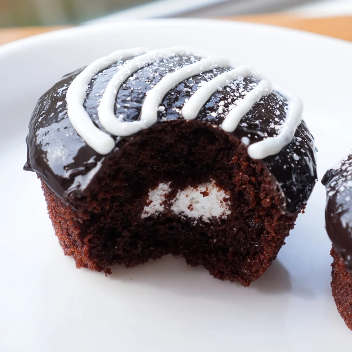 Homemade Hostess Cupcakes with glossy ganache topping and fluffy marshmallow filling