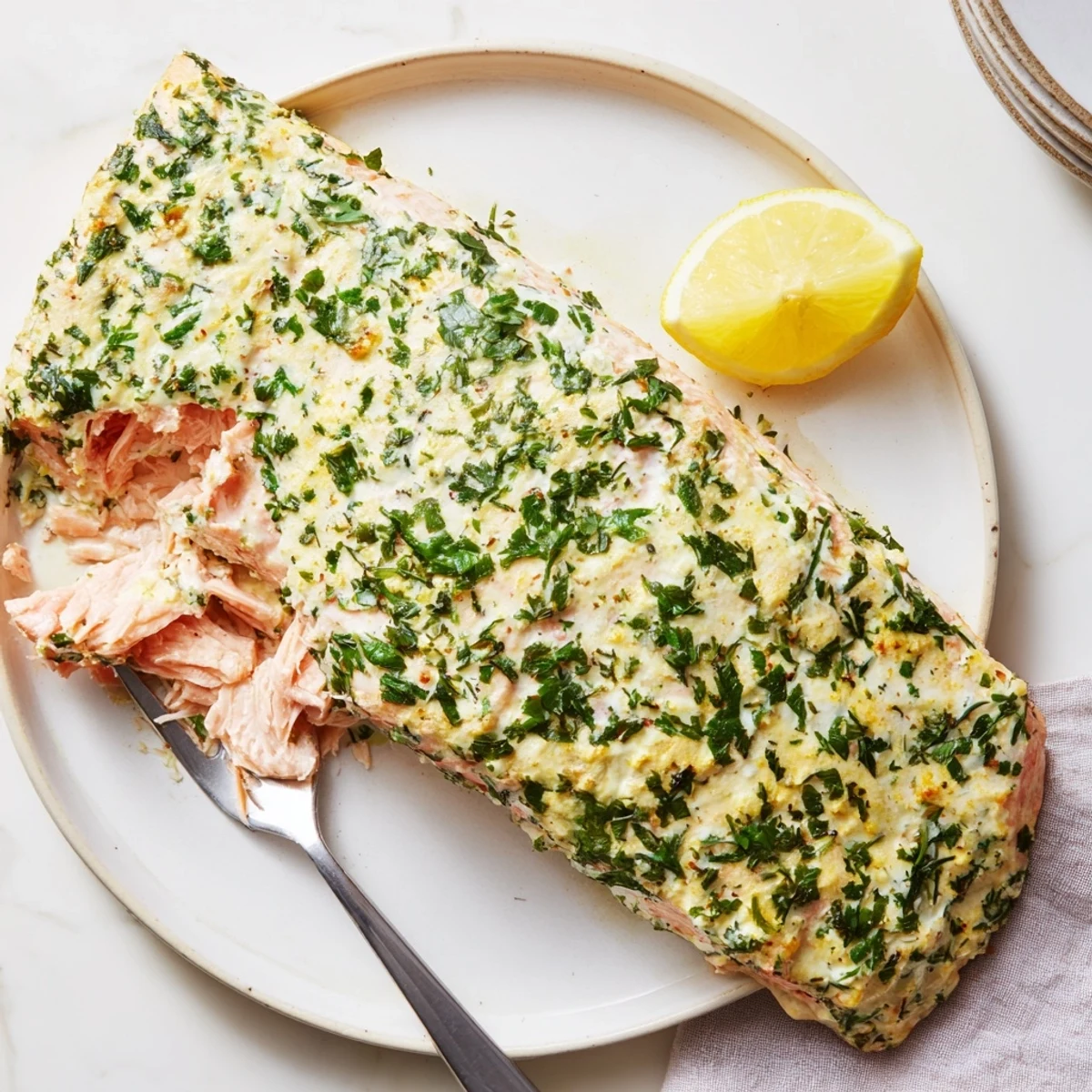 Baked Boursin salmon topped with creamy herb cheese on a parchment-lined sheet
